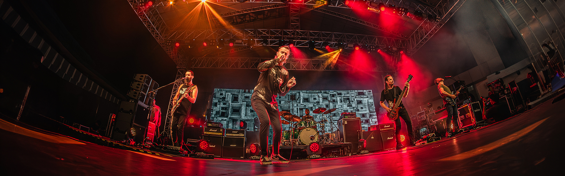 Karnivool full band performing live on stage during India Tour 2024, Ian kenny at centre mecrophone with guitarists and drummer visible behind them